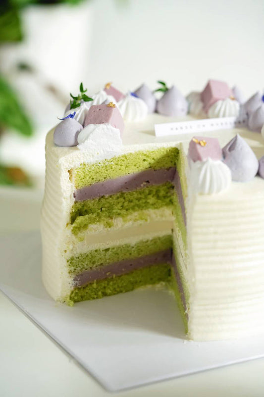 Layers of the Taroo-fic Taro Pandan Cake showing layers of pandan sponge cake with pure taro filling, coconut jelly, taro jelly & Chantilly cream