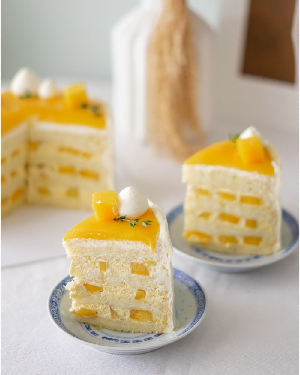Slices of Mango Fresh Cream Cake on plates