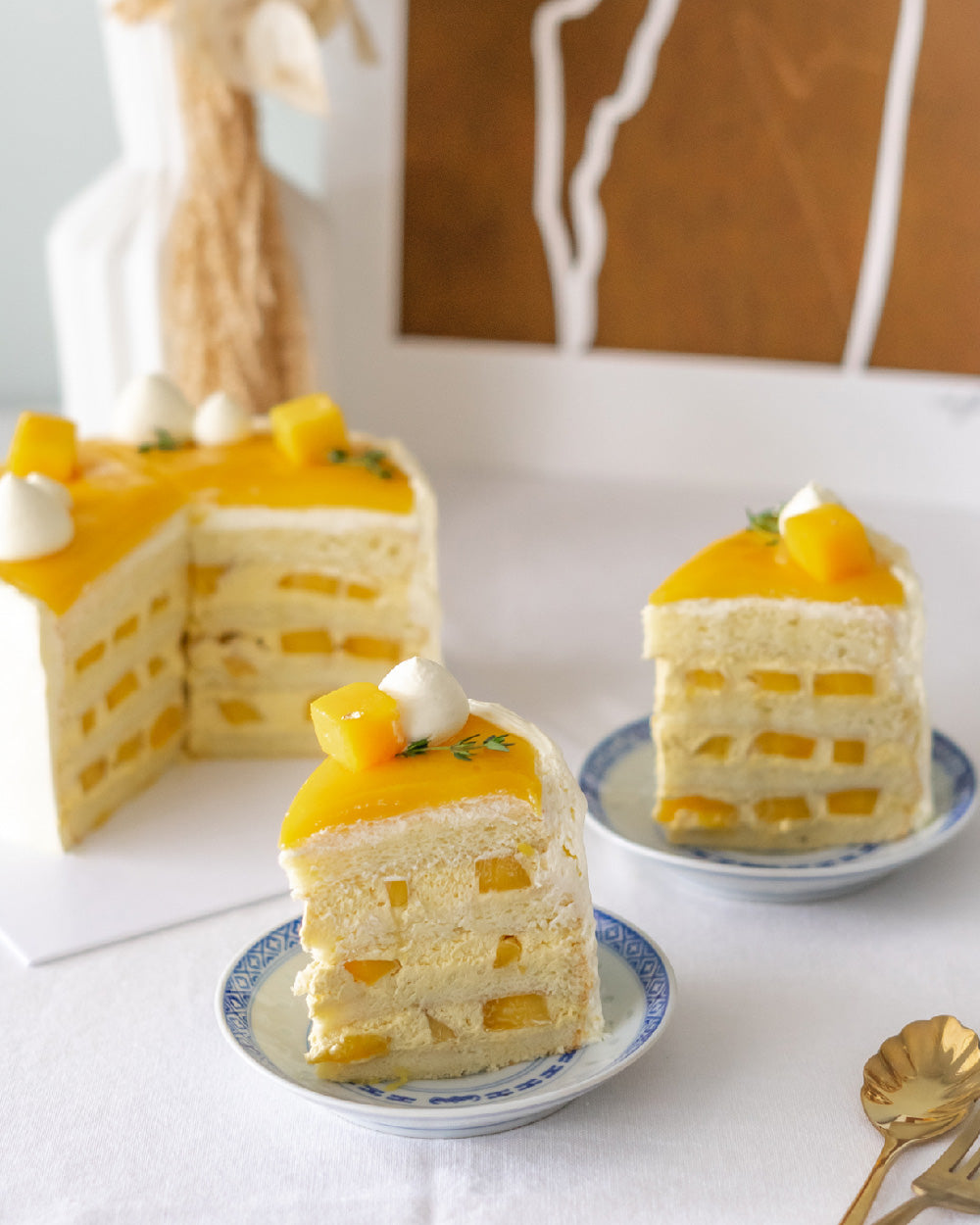 Mango Cake with vanilla sponge, mango fresh cream, fresh mango, Chantilly cream & mango ganache