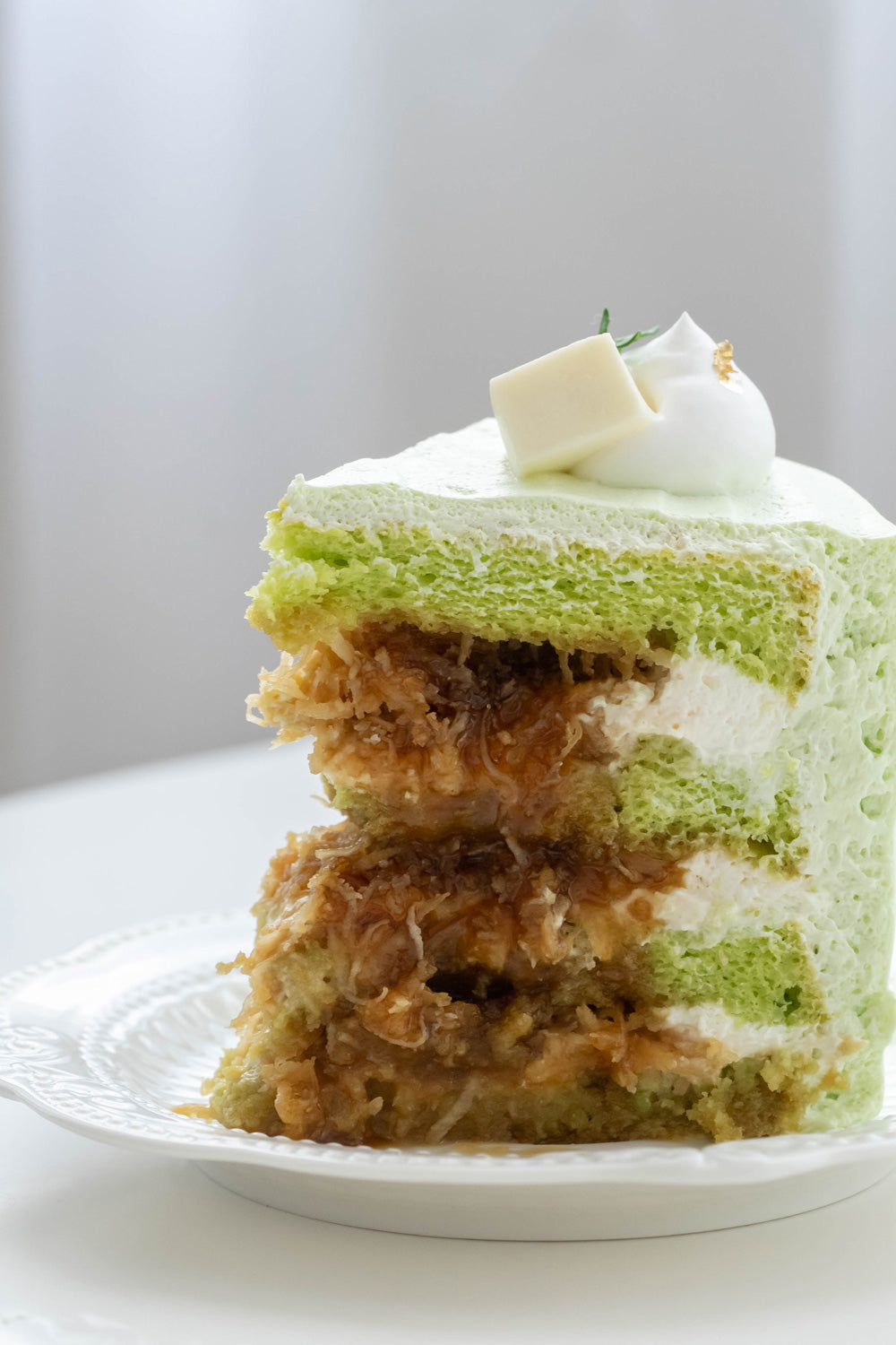 Ondeh Ondeh Cake with Pandan Sponge Cake,  Caramelized Gula Melaka,  Fresh Coconut Flakes,  Pandan Whipping Cream & Coconut Jelly Cubes Topping