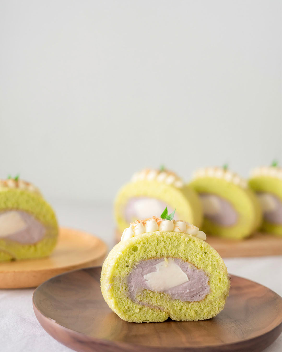 A slice of Fluffy Pandan Sponge cake with Pure Taro Filing (Yam)  and a Coconut Jelly Centre