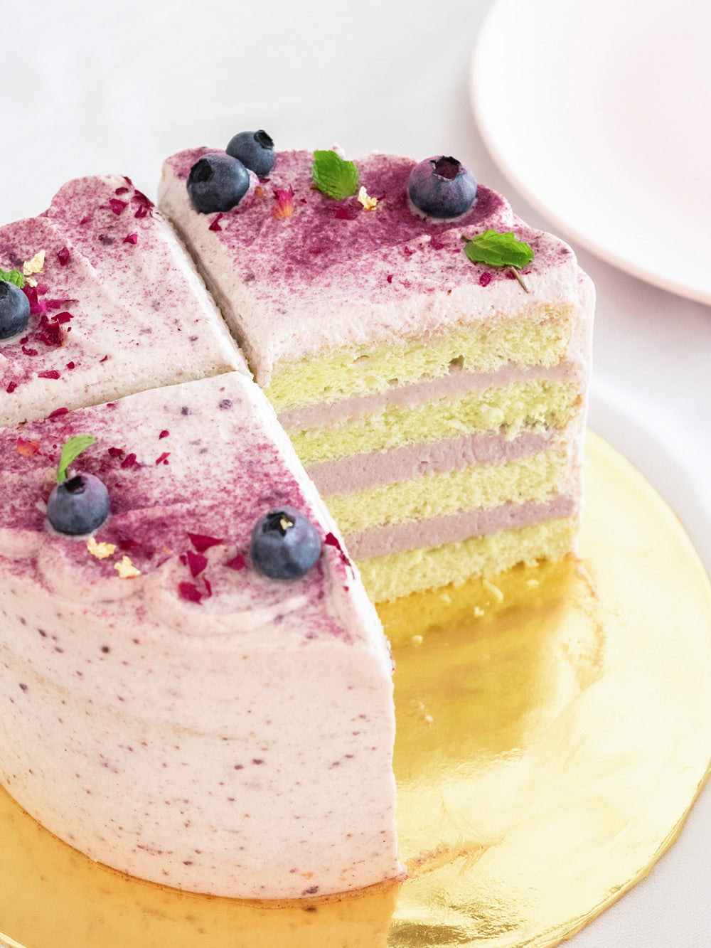 Pandan sponge cake with pure taro filling & sweet potato fresh cream decorated with blueberries and fresh mint leaves